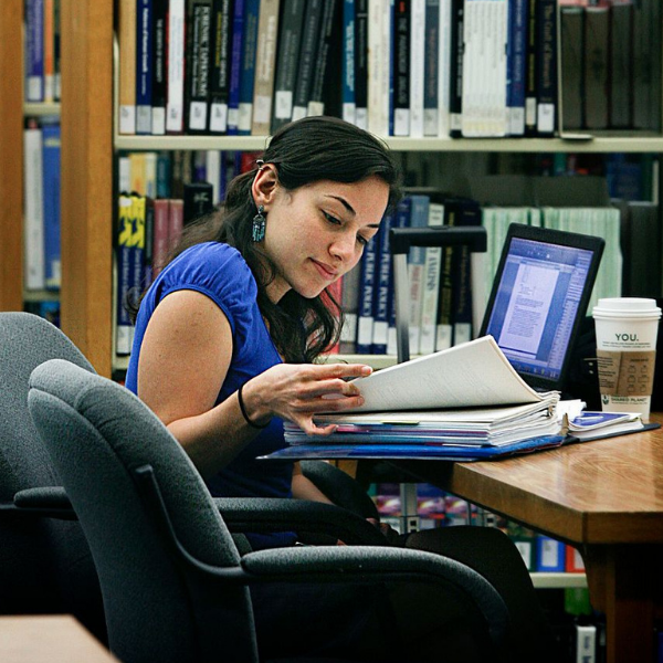 student reading on campus library