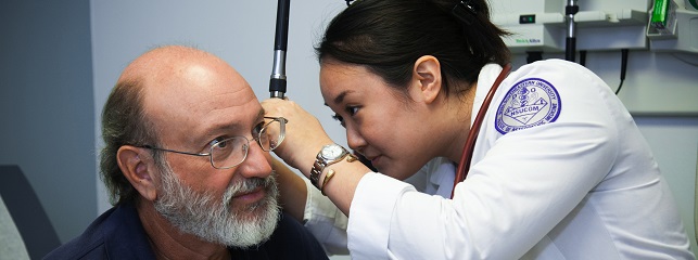 Medical student closely evaluates a patient in the Department of Geriatrics